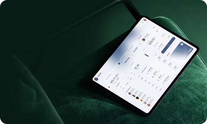 Tablet displaying a financial dashboard resting on a green velvet surface.